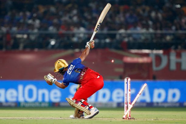 TOPSHOT - Royal Challengers Bengaluru's Mahipal Lomror is clean bowled by Punjab Kings' Harshal Patel during the Indian Premier League (IPL) Twenty20 cricket match between Punjab Kings and Royal Challengers Bengaluru at the Himachal Pradesh Cricket Association Stadium in Dharamsala