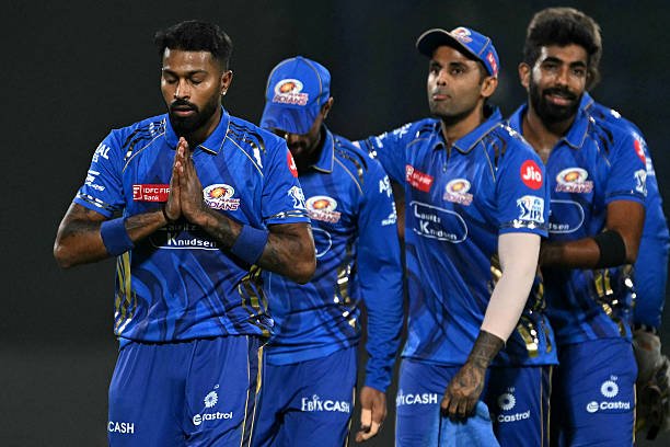 Mumbai Indians' captain Hardik Pandya (L) along with his teammates, walks back to the pavilion after their win at the end of the Indian Premier League