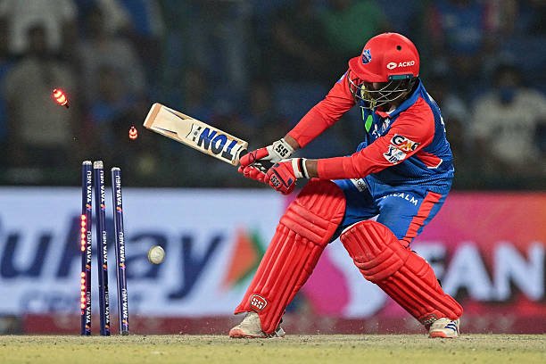 TOPSHOT - Delhi Capitals' Vipraj Nigam is clean bowled by Kolkata Knight Riders' Andre Russell during the Indian Premier League (IPL) Twenty20 cricket match between Delhi Capitals and Kolkata Knight Riders at the Arun Jaitley Stadium in New Delhi