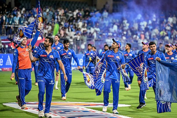 Mumbai Indians' players celebrate their team's win at the end of the Indian Premier League (IPL) Twenty20 cricket match between Mumbai Indians and Delhi Capitals at the Wankhede Stadium